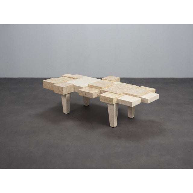 A rare belgian coffee table from the 1970s, defined by an architectural composition of layered natural stone elements. The...
