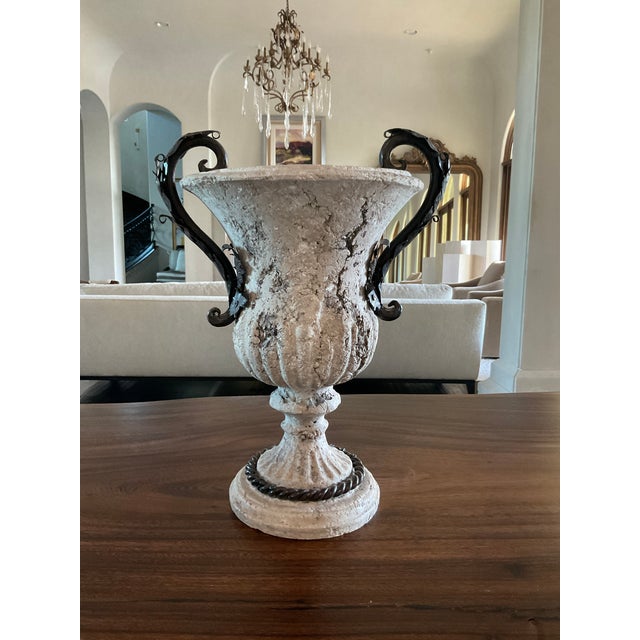 20th Century Distressed Stone and Decorative Iron Urn. Beautiful decorative urn made out of distressed stone with...