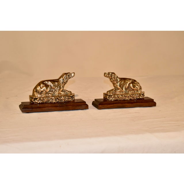 Pair of lovely cast bell metal spaniel mantle decorations from England, mounted on walnut bases. The spaniels are hand...