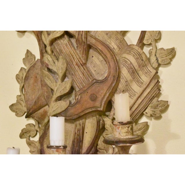 A very special pair of carved wooden sconces probably Italian. Beautifully executed and finished in a faux antique style....