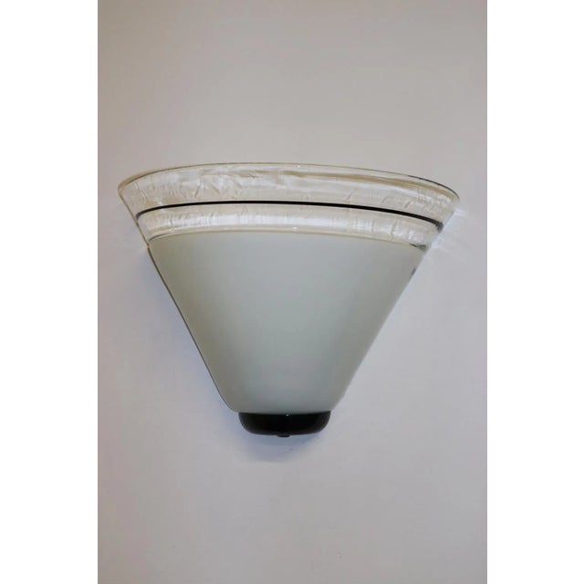 Murano wall Lamp. Hand-Blown White Milky Glass with Applied Crystal Border and submerged black glass tread. Mounting:...