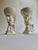Pair of draped and kneeling Off White Glazed Ceramic Putti's and holding adorned Bowls on balanced squat square base....