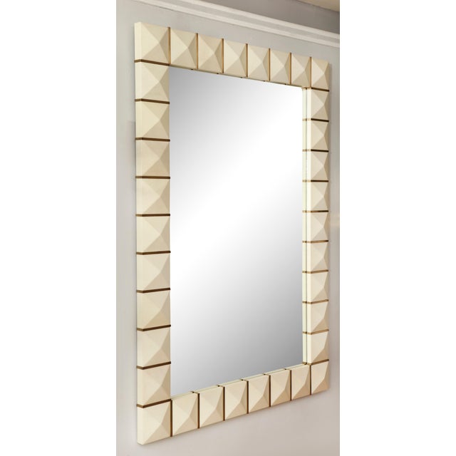 Geometric parchment mirror with inlaid brass.