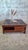 Large square coffee table in solid mahogany/cherry stained wood, with a contemporary design dating from the 1990s. The...