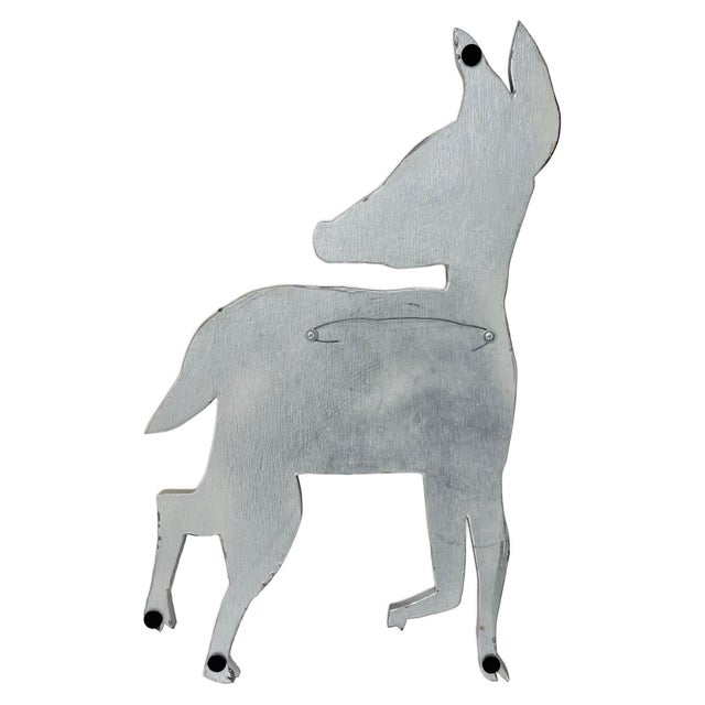 This signed mixed media hanging folk art deer by Pat Custer Denison showcases a playful, expressive interpretation of form...