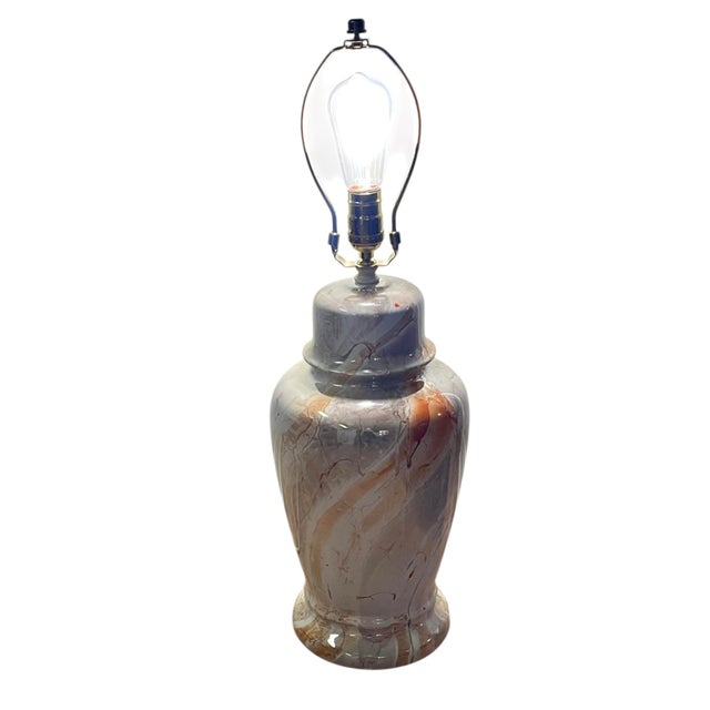 Charming mid century marbleized ceramic lamp. Tones of orange and cream. Lamp has a slight luster. Height of lamp...
