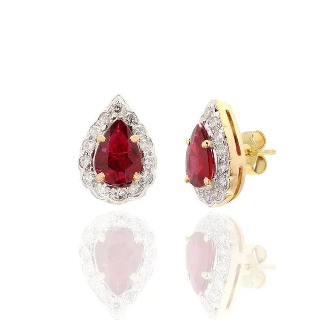This is part of Chairish’s Fine Jewelry assortment. Pear Cut Ruby Diamond Halo Studs in 18K Gold. Embrace your look with...