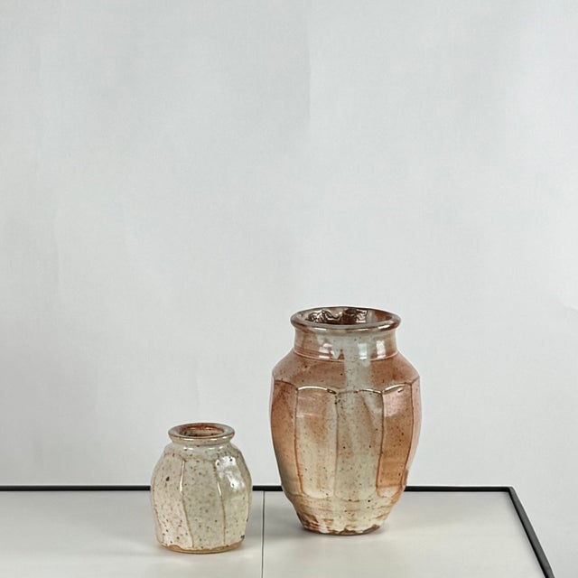 Two faceted glazed pottery vases by Warren MacKenzie. Heavy pieces with thick walls and beautiful glazing. Both stamped at...