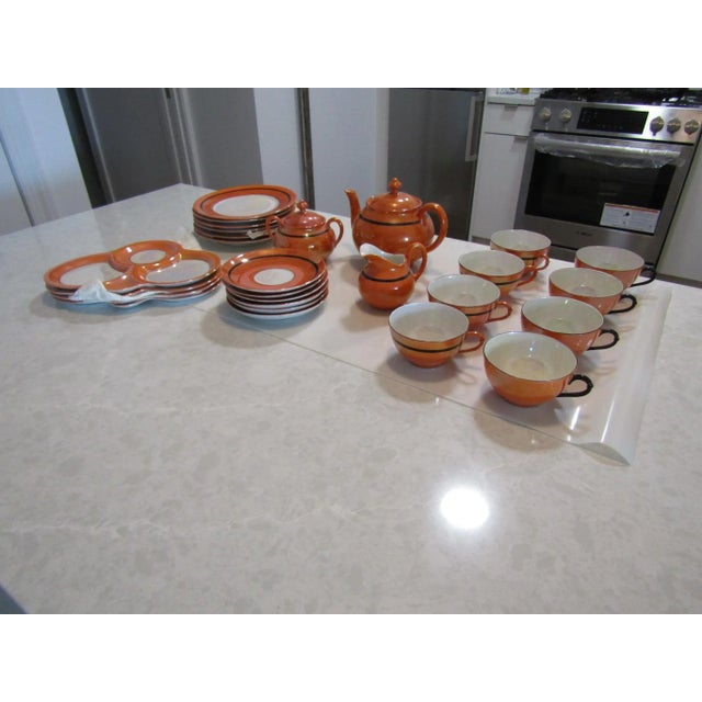 Rudolf Wachter Vintage Orange/Black Lusterware Tea Set. Early 20th Century 27 piece set. This set of inlcudes tea pot,...