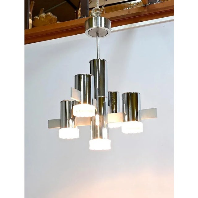 Original and sculptural star chandelier, in polished chrome and brushed aluminum, directed by Gaetano Sciolari and...