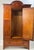 Edwardian-style inlaid mahogany wardrobe. This piece is beautifully adorned with intricate satinwood and fruitwood...