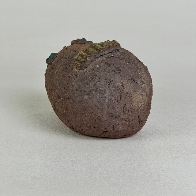 A unique hand formed sculpture of what we deem to be a sea creature of sort. A fish with blue eyes. A lovely and unusual...