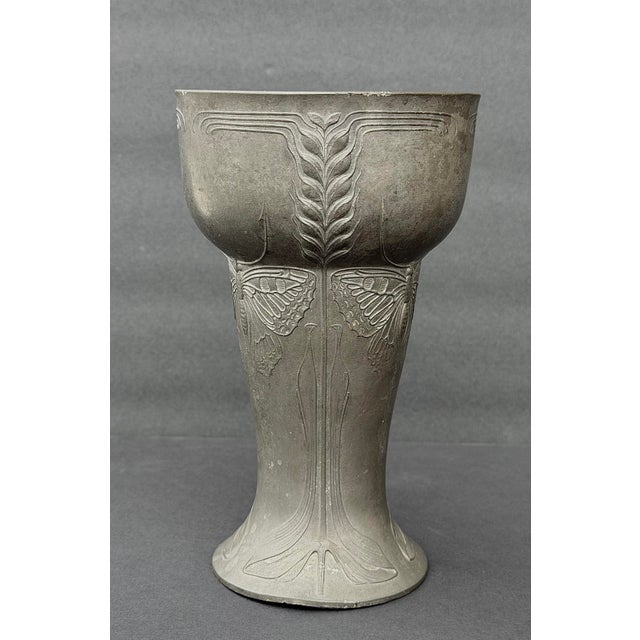 Here is a beautiful example of the Art Nouveau style featuring three butterflies with their wings out stretched and their...