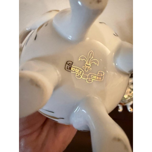 Marked “Limoges China” with a gold fleur-de-lis emblem, this set was produced in the United States during the 1920s–1940s,...