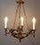 Decorative baroque chandelier made of bronze, decorated with plastic putti figures that carry individual light arms. The...
