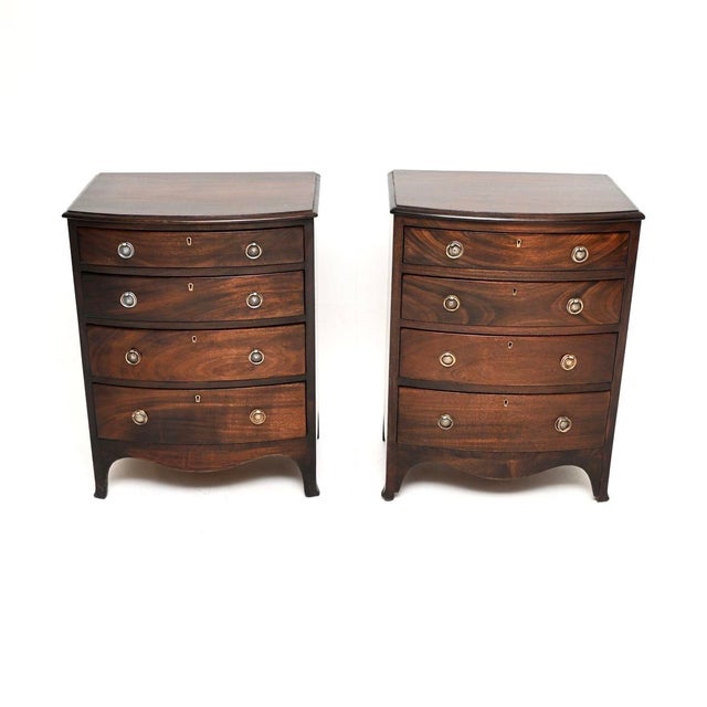 A wonderful pair of antique bow fronted chest of drawers. They were made in England, they are in the Georgian revival...