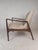 This gorgeous mid-century style lounge chair features a sculpted frame with angled back legs. The high back rest and...