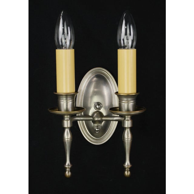 These Traditional pair of two arm nickeled brass wall sconces showcases timeless elegance. Meticulously refurbished, these...