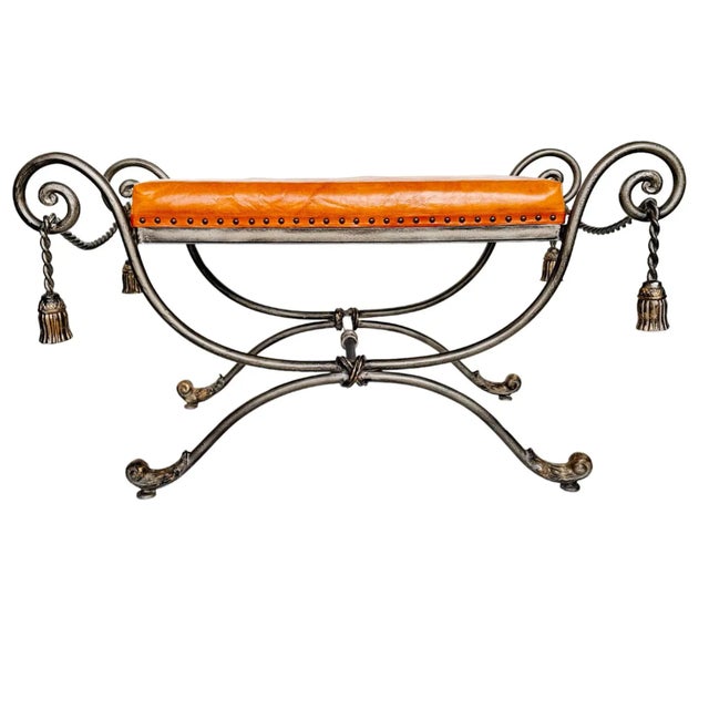 Gray steel bench or vanity stool with gold tassels and brown leather seat. Solid and heavy.