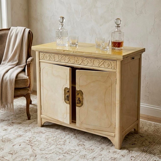 Elevate your home entertaining with this exquisite 1970s Hollywood Regency flip-top bar cabinet, meticulously crafted by...