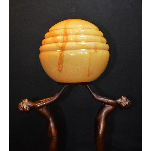 A striking original French Art Deco figural table lamp dating to circa 1930, combining a sculptural female dancer with...