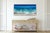 This mixed media artwork captures the dynamic movement of ocean waves, with a vibrant interplay of blues and greens that...