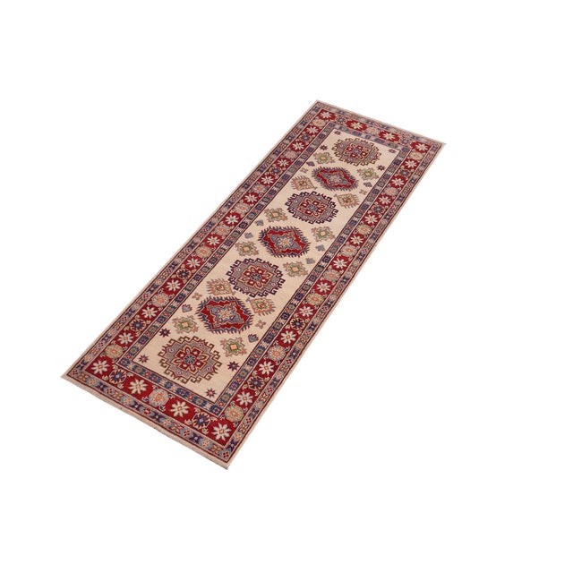 Enhance your home with this exquisite hand-knotted Kazak rug, crafted from fine hand-spun wool and dyed with all-natural...