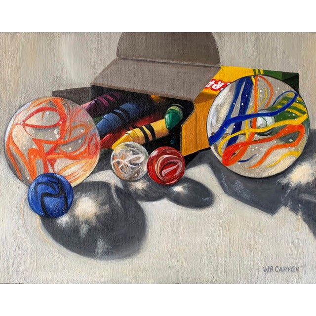 This oil on linen panel depicts a playful arrangement of colorful marbles and crayons emerging from an open box, casting...