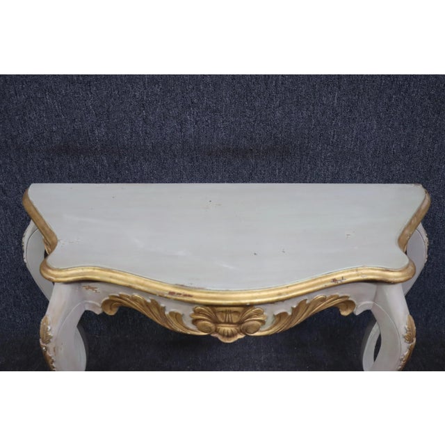Louis XV style gray distressed demi-lune console with gilded carved accents and cabriole legs by Furniture Classics.