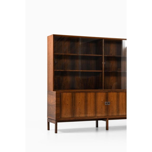 This very rare sideboard with a display cabinet was designed by hans wegner and produced by ry møbler in denmark in 1965....