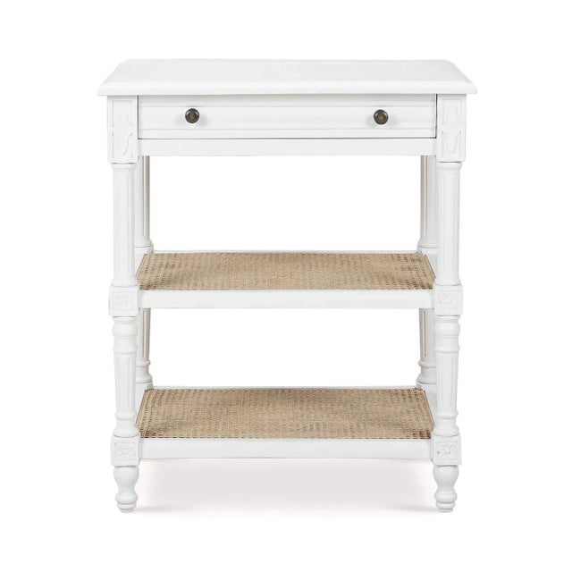 This end table features a solid wood frame finished in a lightly distressed architectural white paint, providing both...