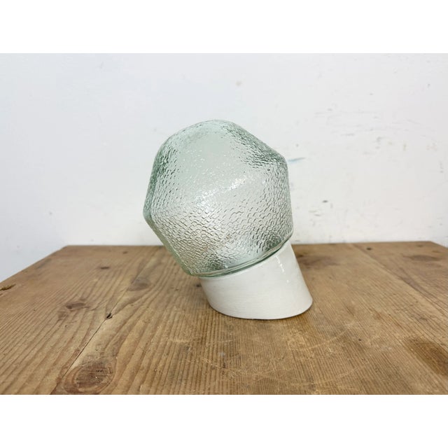 Vintage industrial light made in Poland during the 1970s. It features a white porcelain wall mounting and a frosted glass...