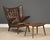 An original signed teak Papa Bear chair designed by Hans J. Wegner for AP Stolen in brown vinyl. Minor imperfections in...