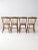 Set of four antique wooden dining chairs featuring beautifully stenciled backs and classic country craftsmanship. Each...