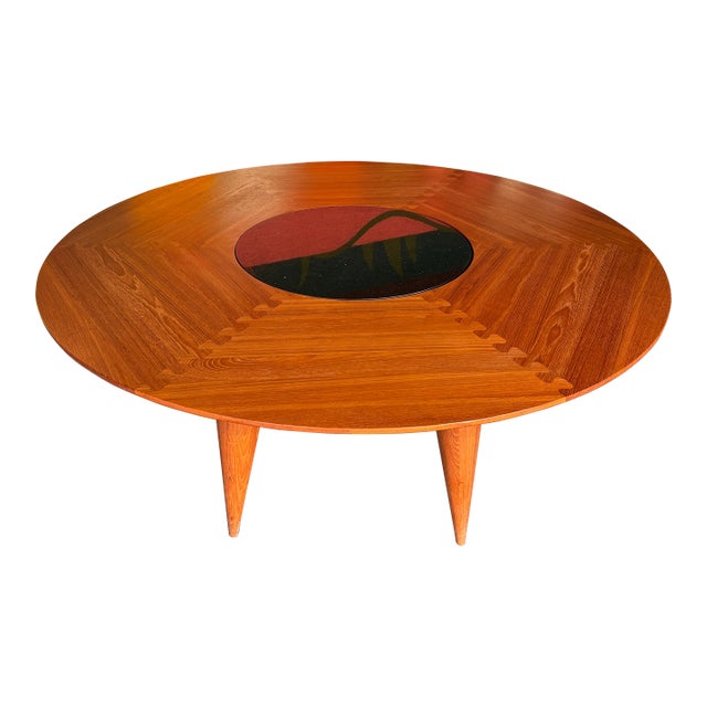 Everything about this table is incredible! The solid teak, the joinery on the top, the conical legs, the lazy susan. Such...