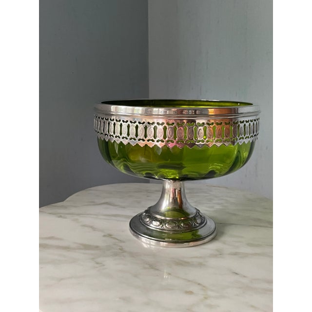 This highly unusual vintage/antique bowl is a beautiful shade of green glass with a pierced silver plate overlay and...