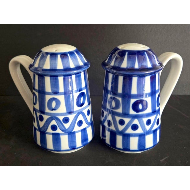 Offered is a blue and white ceramic set of Salt and Pepper shakers in the Arabesque pattern by Dansk designed by Niels...