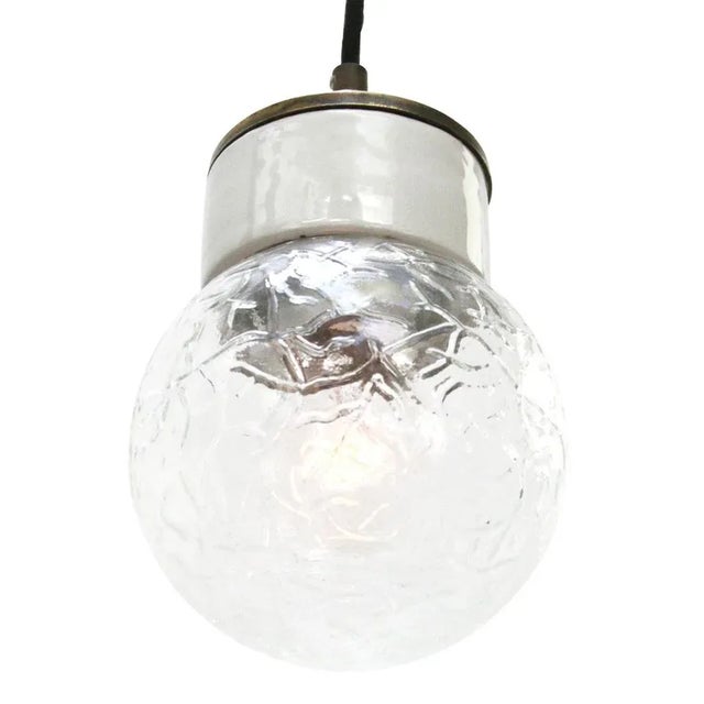 Porcelain and brass industrial pending lamp. White porcelain, brass top and clear structured glass. 2 meter black cotton...