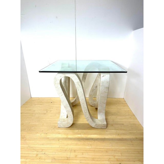 Large occasional table with looped base made of tessellated stone with square glass top. Attr. to Casa Bique Philipines...