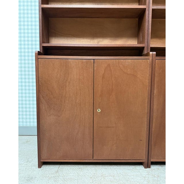 Elegant and functional, this large vintage bookcase with scandinavian inspiration captivates with its clean lines and warm...