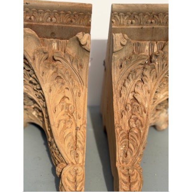 A beautifully carved pair of vintage wood corbels, featuring classic architectural detailing and a rich, time-worn patina....