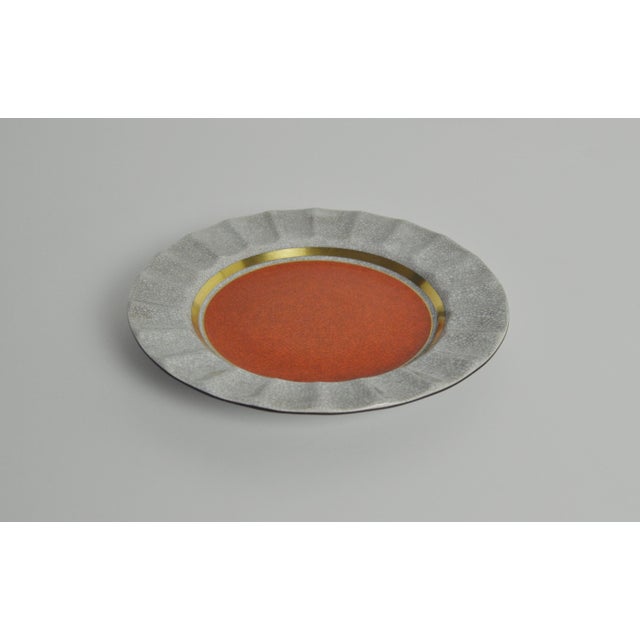 Elegant Royal Copenhagen crackle glazed ashtray. Orange-brown on grey crackle glaze with gilded bands. Pale grey crackle...