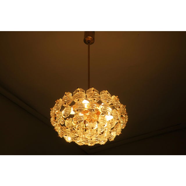 Kinkeldey chandelier in gold plated brass from the 1960s with faceted glass crystals cut in octagonal shapes hanging from...