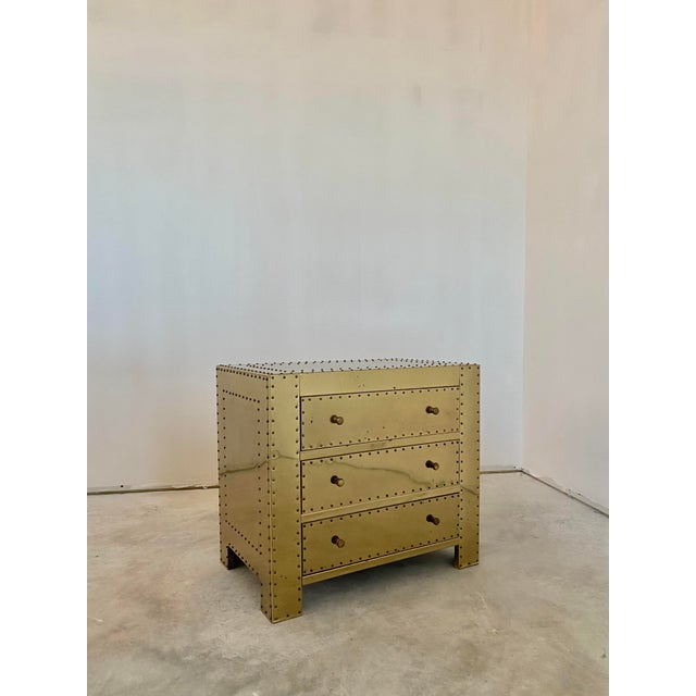Brass-clad and hand-tacked three-drawer chest in the style of Sarreid, Spain. A beautifully crafted and weighty piece,...