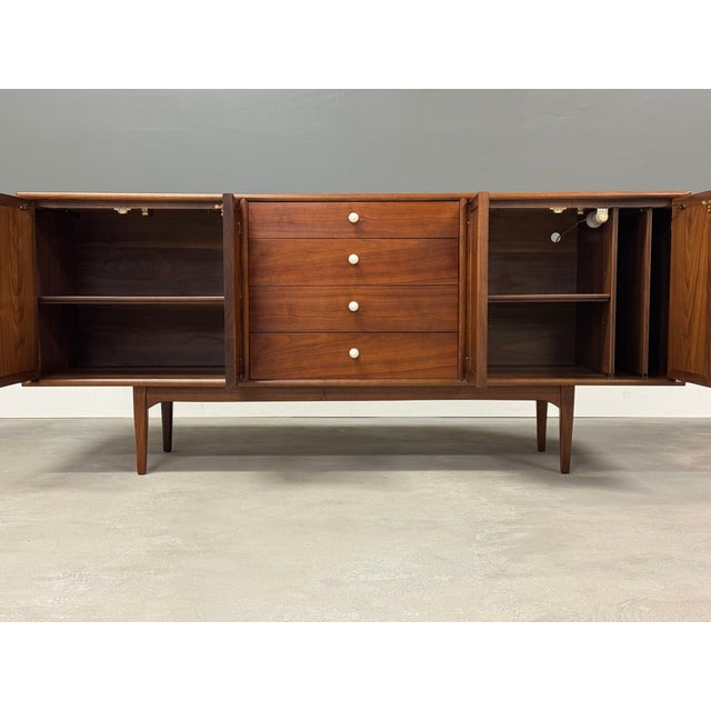 A mid century modern walnut sideboard credenza designed by Kipp Stewart and Stewart MacDougall for Drexel’s Declaration...