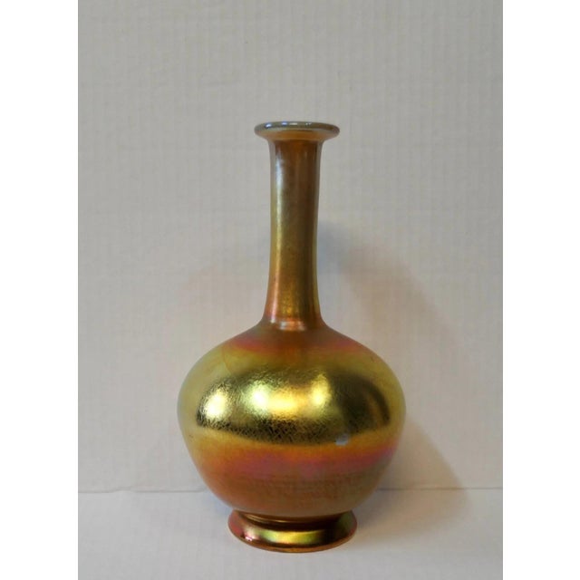 This vintage Tiffany Studios favrile art glass vase dates from the early 20th century. The hand blown vessel has a bulbous...