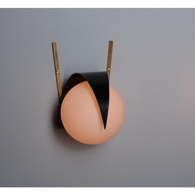 Introducing a singular italian mid-century wall sconce, attributed to the renowned design lineage of stilnovo. This lamp...