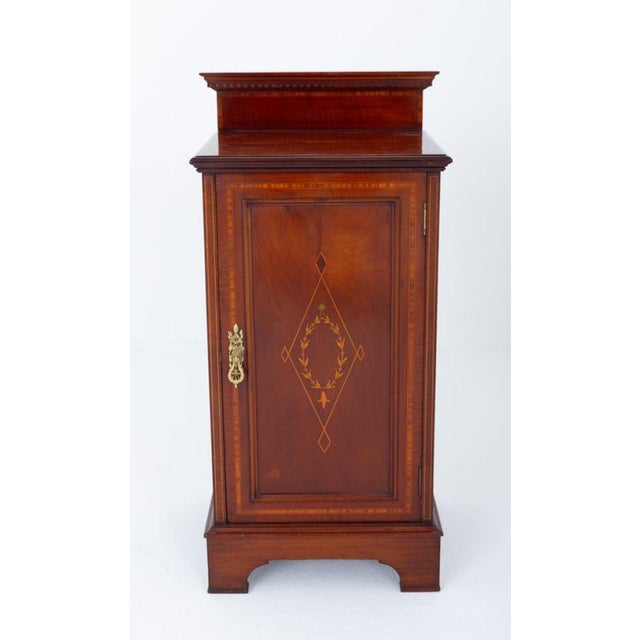 Sheraton revival mahogany bedside cabinet Circa 1900 This cabinet stands upon bracket feet The door featuring a central...