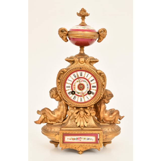 An exquisite French three-piece clock garniture crafted during the mid to late 19th century, beautifully combining richly...