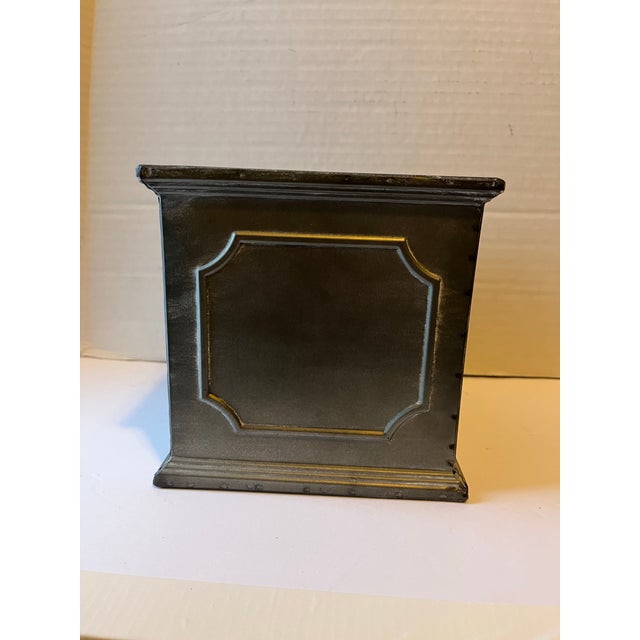 A single square metal cachepot with raised panel sides.